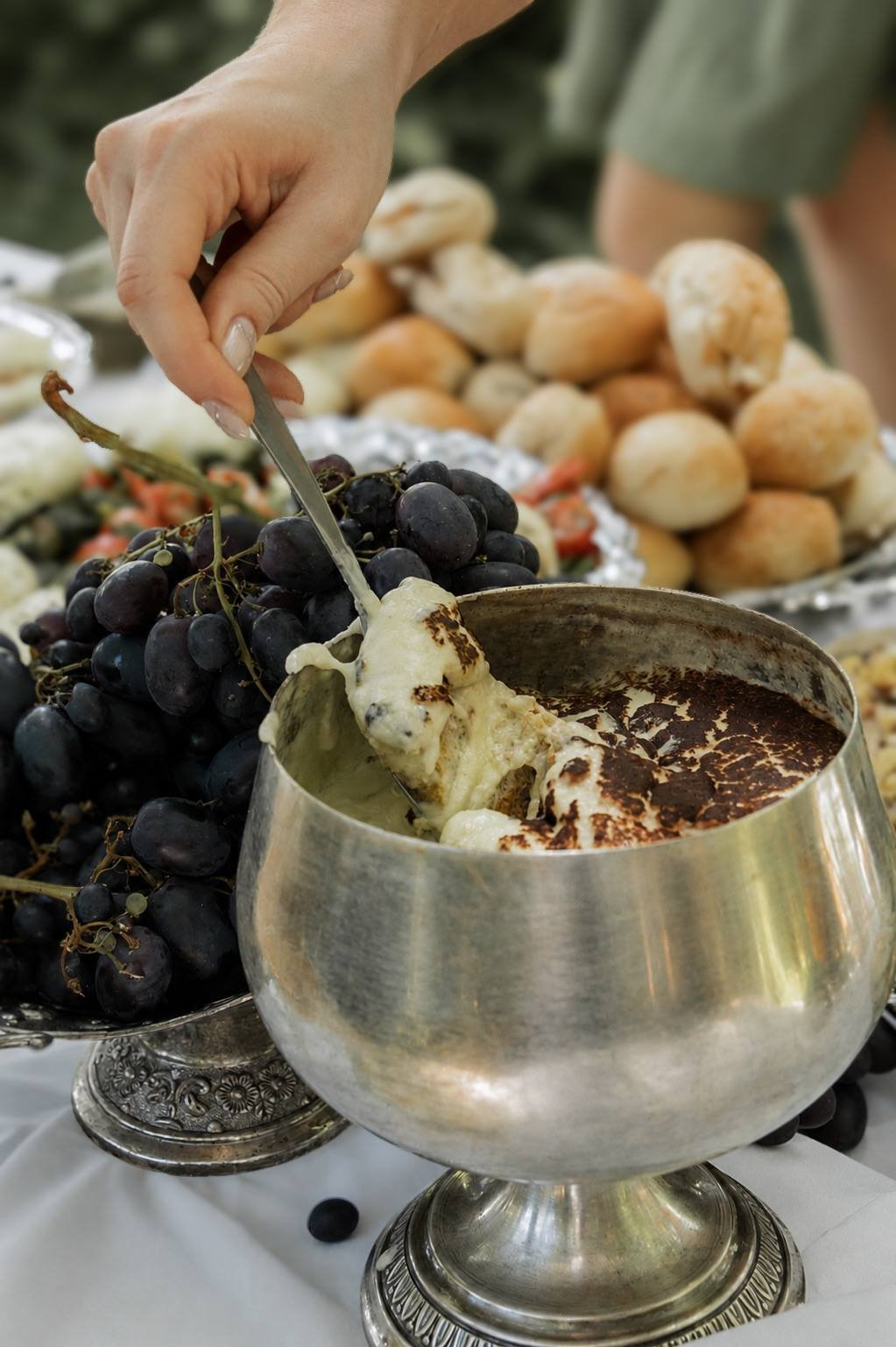 Service au buffet : main, raisins et pâte à tartiner dans une coupe en argent